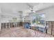 Dining area featuring terracotta tile flooring, large window, ceiling fan and waterfront view at 396 Avenida Madera, Sarasota, FL 34242