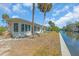 Exterior of home showing waterfront canal access with lush tropical landscaping at 396 Avenida Madera, Sarasota, FL 34242