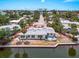 Charming waterfront home featuring a private dock, outdoor deck, and tropical landscaping at 396 Avenida Madera, Sarasota, FL 34242