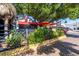 Inviting outdoor patio with lush greenery, red umbrellas, and a Siesta Key Oyster Bar sign at 396 Avenida Madera, Sarasota, FL 34242