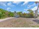 Charming home featuring an attached garage, mature landscaping, and a spacious driveway at 396 Avenida Madera, Sarasota, FL 34242