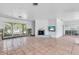 Open living room featuring tile flooring, large windows, and a cozy fireplace, ready for customization at 396 Avenida Madera, Sarasota, FL 34242