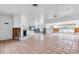 Spacious living room with a cozy fireplace, tile floors, and abundant natural light from large windows at 396 Avenida Madera, Sarasota, FL 34242