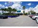 A modern waterfront facility with ample parking and palm trees, offering a welcoming entrance for visitors at 396 Avenida Madera, Sarasota, FL 34242