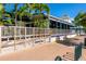 Charming outdoor dining area at the Daiquiri Deck restaurant in Siesta Key with a sidewalk and palm trees at 396 Avenida Madera, Sarasota, FL 34242