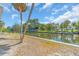 Waterfront property showing private boat dock and canal access amid tropical palm trees at 396 Avenida Madera, Sarasota, FL 34242