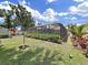 Landscaped backyard showcasing the pool and screen enclosure at 4175 20Th N St, St Petersburg, FL 33741