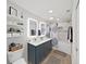 Bright bathroom with a double sink vanity, modern mirrors, shower/tub combo, and stylish blue accents at 4175 20Th N St, St Petersburg, FL 33741
