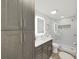 Stylish bathroom featuring an LED mirror, glass shower, neutral accents and cabinetry for ample storage at 4175 20Th N St, St Petersburg, FL 33741