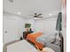 Cozy bedroom featuring a ceiling fan, orange accents, white rug, and a closet with white doors at 4175 20Th N St, St Petersburg, FL 33741