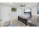 Comfortable bedroom with a dark wood bed frame, blue bedding, and a view of a TV on the wall at 4175 20Th N St, St Petersburg, FL 33741
