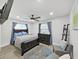 Serene bedroom featuring a dark wood bed frame, blue bedding, gray rug, and modern accents at 4175 20Th N St, St Petersburg, FL 33741