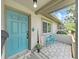 Inviting entrance with a stylish turquoise door and a cozy seating area on the porch at 4175 20Th N St, St Petersburg, FL 33741