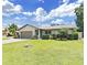 Charming single-story home featuring a well-manicured lawn and tropical landscaping at 4175 20Th N St, St Petersburg, FL 33741