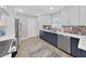 Renovated kitchen featuring two-tone cabinetry, stainless steel appliances, and a decorative backsplash at 4175 20Th N St, St Petersburg, FL 33741