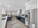 Open kitchen featuring stainless steel appliances and blue-and-white cabinetry with connection to dining area at 4175 20Th N St, St Petersburg, FL 33741