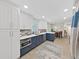 Spacious kitchen featuring a stainless-steel microwave, and blue-and-white cabinetry, with an open layout to the dining area at 4175 20Th N St, St Petersburg, FL 33741