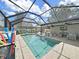 This outdoor pool area includes a screened-in pool and a seating area at 4175 20Th N St, St Petersburg, FL 33741