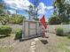 Outdoor shed located in a fenced backyard with manicured plants at 4175 20Th N St, St Petersburg, FL 33741