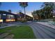 Expansive backyard with modern architectural elements, a pool, and a lush green lawn at 4610 Cypress S Way, St Petersburg, FL 33705