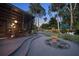 Landscaped backyard featuring a curved pathway, manicured lawn, and an enclosed outdoor entertainment area at 4610 Cypress S Way, St Petersburg, FL 33705