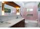 Bathroom featuring unique pink tile work, modern fixtures and a glass shower at 4610 Cypress S Way, St Petersburg, FL 33705