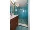 Updated bathroom featuring a modern shower with glass door, tiled walls and floors, and wood vanity with sink at 4610 Cypress S Way, St Petersburg, FL 33705