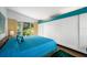 Bedroom featuring a bright color scheme, large window and plenty of closet space at 4610 Cypress S Way, St Petersburg, FL 33705