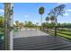 Spacious deck with wooden railing, offering scenic views of the surrounding green landscape at 4610 Cypress S Way, St Petersburg, FL 33705