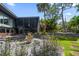 Exterior view of the modern home showcasing lush landscaping and unique architecture at 4610 Cypress S Way, St Petersburg, FL 33705