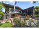 Beautiful exterior of modern home featuring lush gardens and unique architectural details at 4610 Cypress S Way, St Petersburg, FL 33705