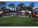 Eye-catching modern home with a vibrant blue door and manicured lawn at 4610 Cypress S Way, St Petersburg, FL 33705