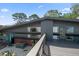 Exterior view of the home from the deck showing modern lines and mature landscaping at 4610 Cypress S Way, St Petersburg, FL 33705
