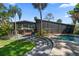 Modern home with screened-in porch, pool, curved steps, and tropical landscaping at 4610 Cypress S Way, St Petersburg, FL 33705
