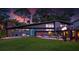 Charming, mid-century home with a modern gray exterior, lush lawn, and eye-catching landscaping at 4610 Cypress S Way, St Petersburg, FL 33705