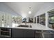 Open floor plan features a kitchen island with bar seating, stainless steel appliances, and backyard access at 4610 Cypress S Way, St Petersburg, FL 33705