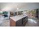 Open floor plan features a kitchen island with bar seating, stainless steel appliances, and backyard access at 4610 Cypress S Way, St Petersburg, FL 33705