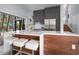 Bright kitchen features a breakfast bar with seating, stainless steel appliances, and modern cabinetry at 4610 Cypress S Way, St Petersburg, FL 33705