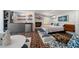 Living room featuring small kitchenette, modern fireplace, and a sleeping area at 4610 Cypress S Way, St Petersburg, FL 33705