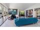 Bright living room with sleek furniture, white brick fireplace, and a view of outdoor grilling area through glass doors at 4610 Cypress S Way, St Petersburg, FL 33705