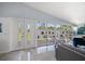 Bright living room featuring a wall of windows and a double door with exterior views at 4610 Cypress S Way, St Petersburg, FL 33705