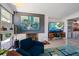 Cozy living room with stylish decor, brick fireplace, and seamless flow to outdoor space at 4610 Cypress S Way, St Petersburg, FL 33705