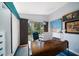 Bright office boasts a unique wood desk, blue accents, and backyard views at 4610 Cypress S Way, St Petersburg, FL 33705
