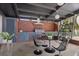 An outdoor kitchen and dining area offers ample space for entertaining with views of the backyard at 4610 Cypress S Way, St Petersburg, FL 33705