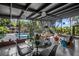 A sunroom offers a dining area with views of the pool and beautifully landscaped backyard at 4610 Cypress S Way, St Petersburg, FL 33705