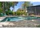 Beautiful pool area with brick pavers and lush tropical landscaping, perfect for relaxation and privacy at 4610 Cypress S Way, St Petersburg, FL 33705