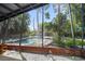 View of backyard pool and lush garden area from the enclosed porch at 4610 Cypress S Way, St Petersburg, FL 33705