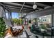 Relaxing sunroom featuring terrazzo floors, rattan seating, and abundant natural light at 4610 Cypress S Way, St Petersburg, FL 33705