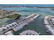 Stunning aerial view of waterfront homes with docks, surrounded by beautiful blue water and distant city skyline at 467 Boca Ciega Point S Blvd, St Petersburg, FL 33708
