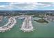 Scenic aerial view showcasing a waterfront condo community with boat docks, winding waterways, and lush greenery at 467 Boca Ciega Point S Blvd, St Petersburg, FL 33708